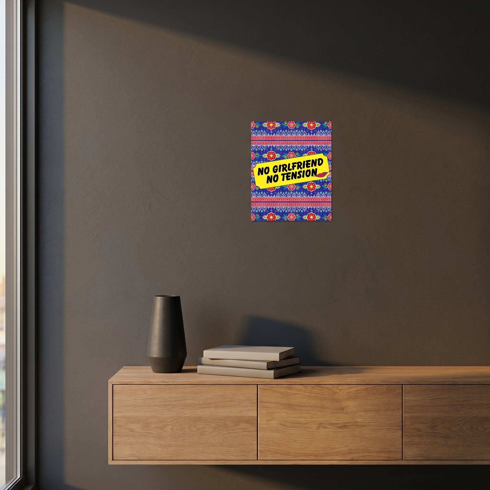 Humorous South Asian diaspora aluminum slogan sign styled on a dark grey accent wall over a modern wooden sideboard cabinet.