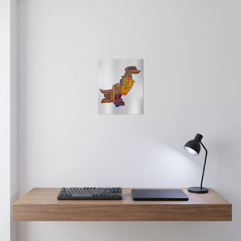 Pakistani colorful cultural map metal poster styled on a contemporary bedroom nightstand catching warm ambient light from an elegant bedside lamp.