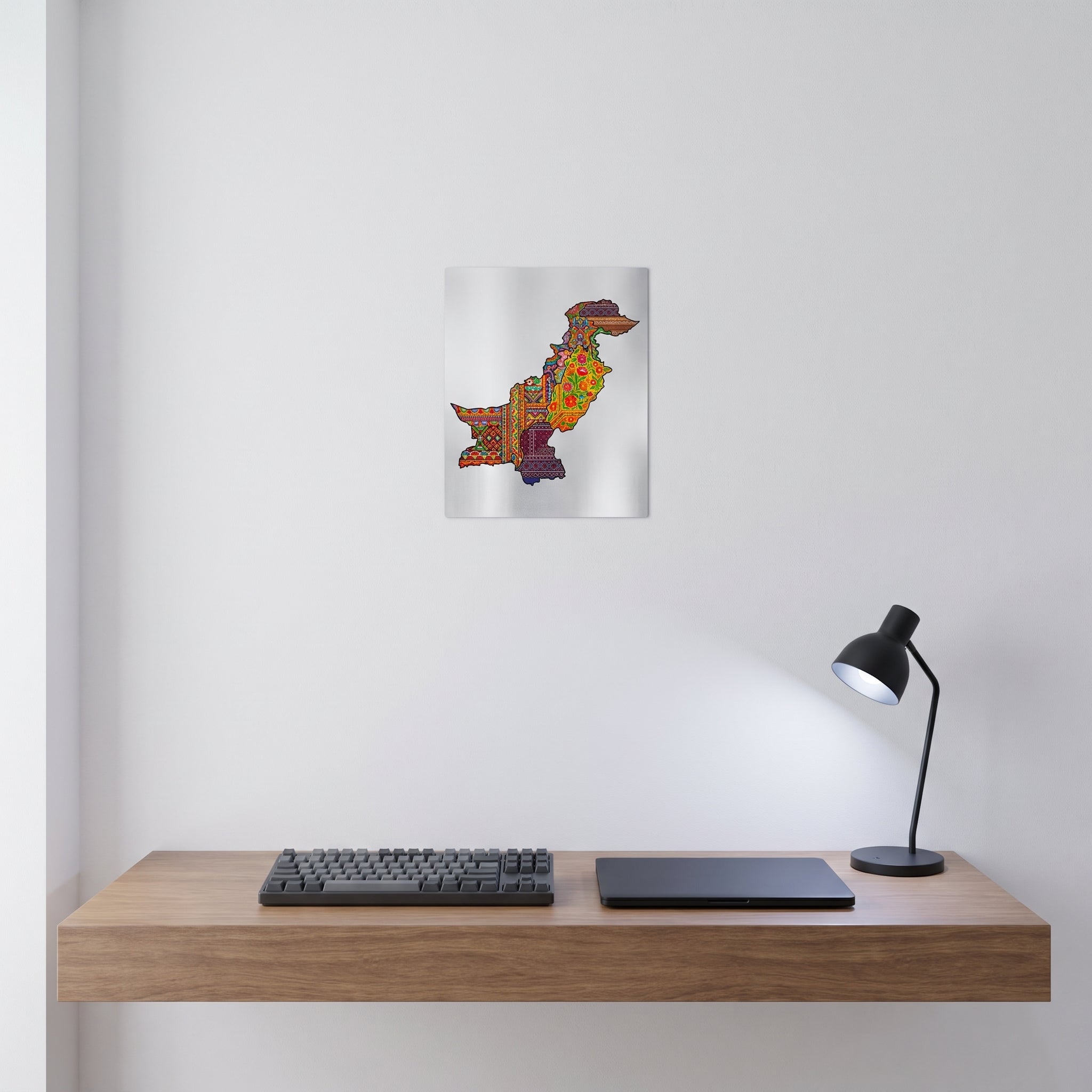 Pakistani colorful cultural map metal poster styled on a contemporary bedroom nightstand catching warm ambient light from an elegant bedside lamp.