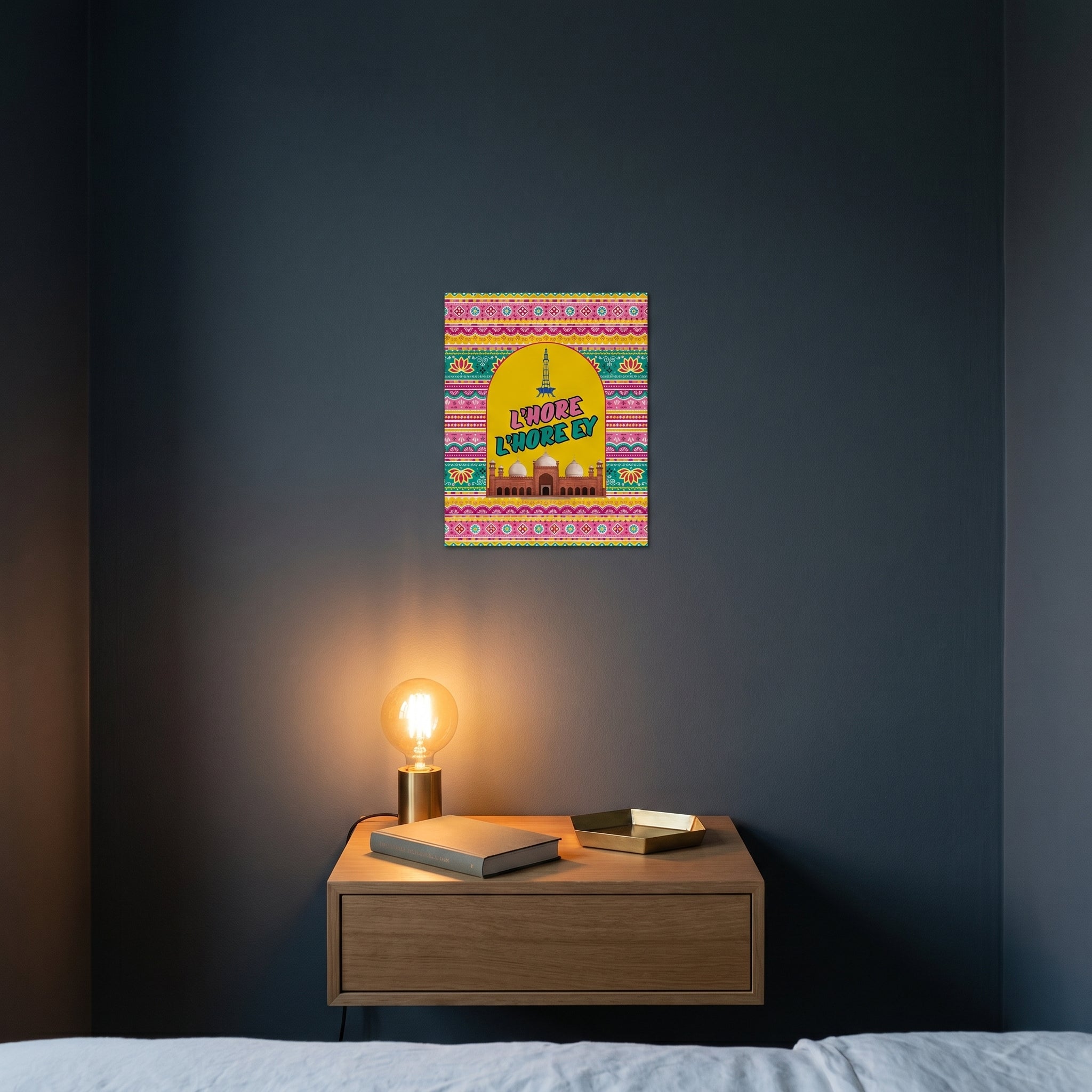 Pop-art style Punjabi heritage metal print catching warm ambient light from a lamp on a contemporary dark bedroom nightstand.
