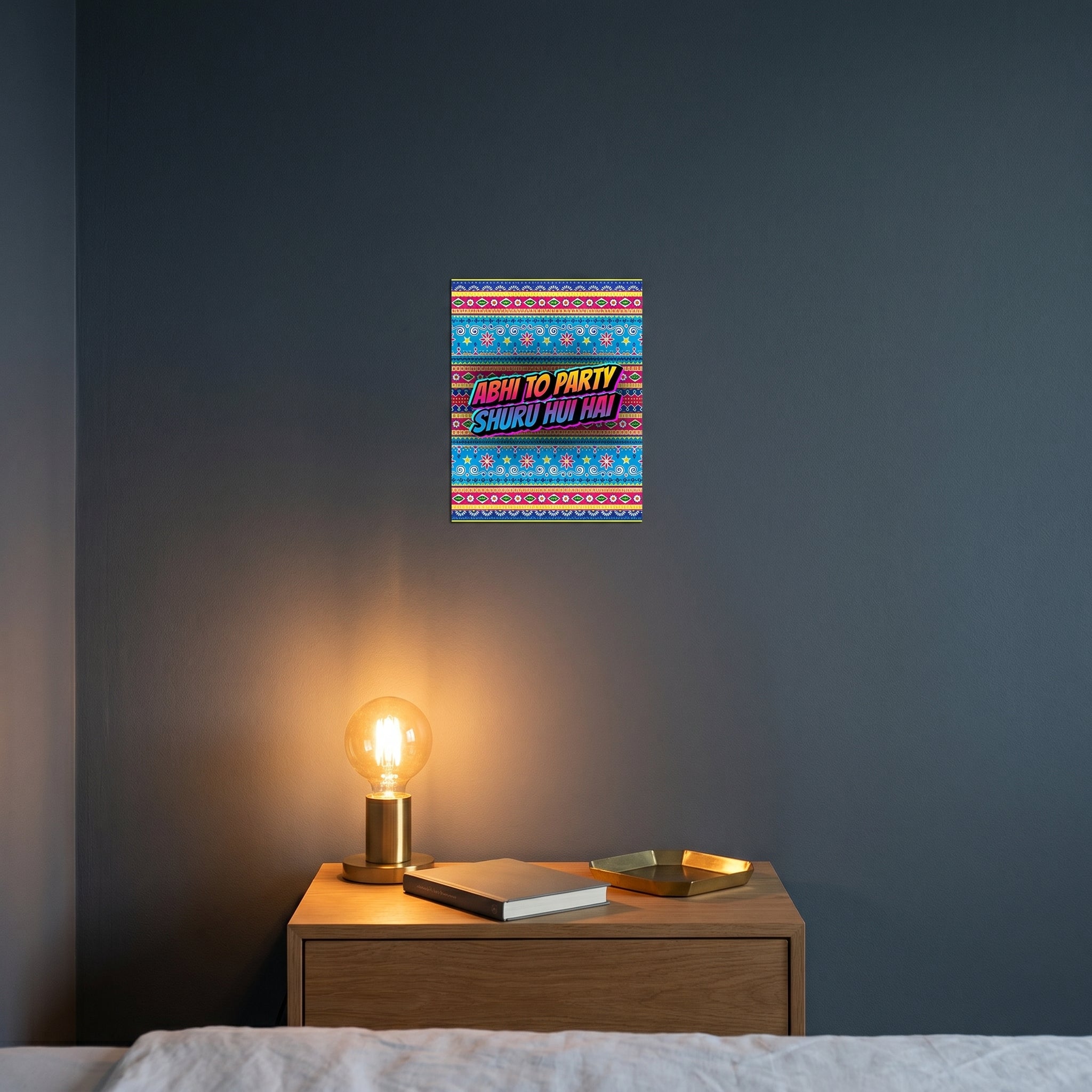 Pop-art style Urdu truck art print catching warm ambient light from a lamp on a contemporary dark bedroom nightstand.
