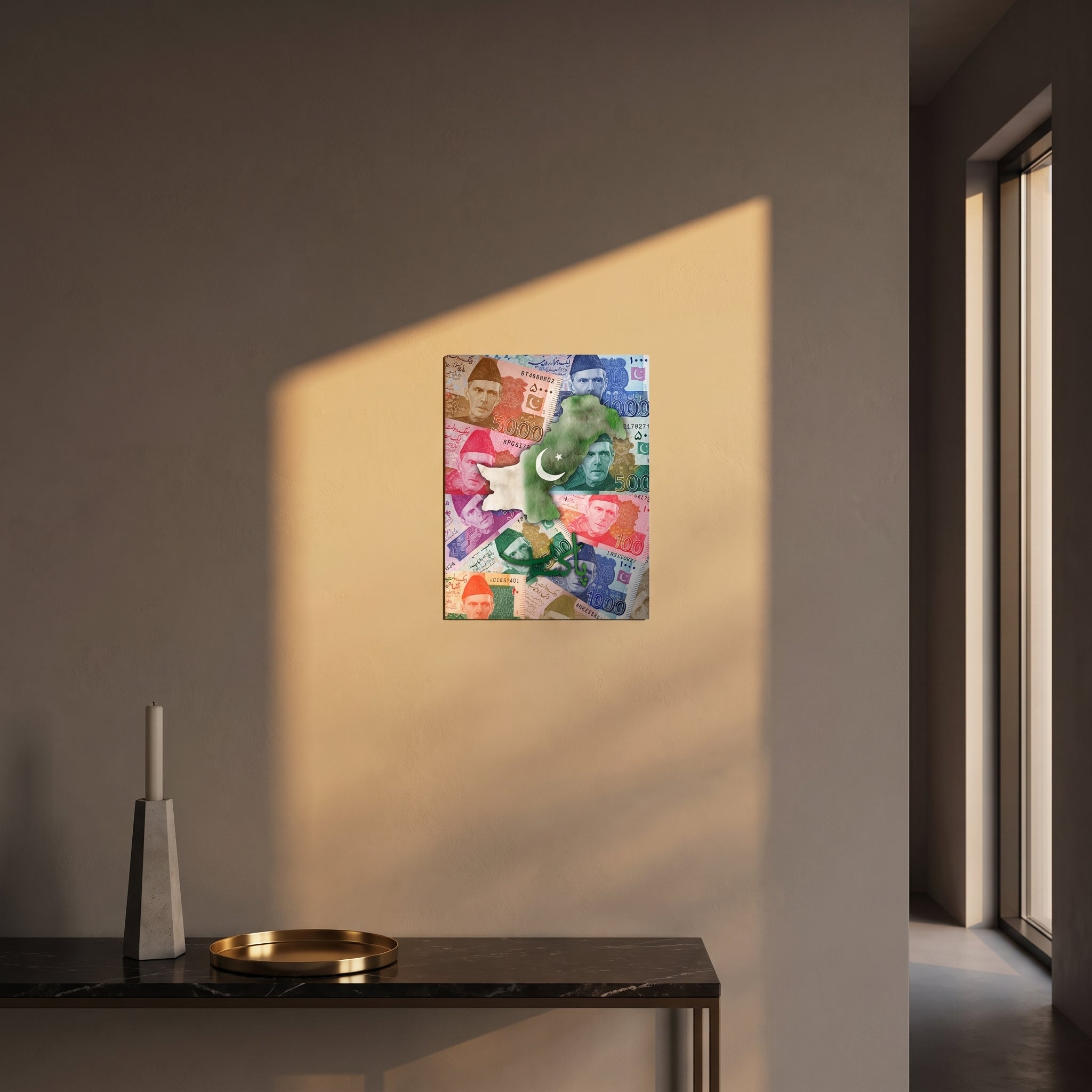 Pop-art style currency collage theme metal print catching warm afternoon window sunlight on a textured plaster wall above a table.
