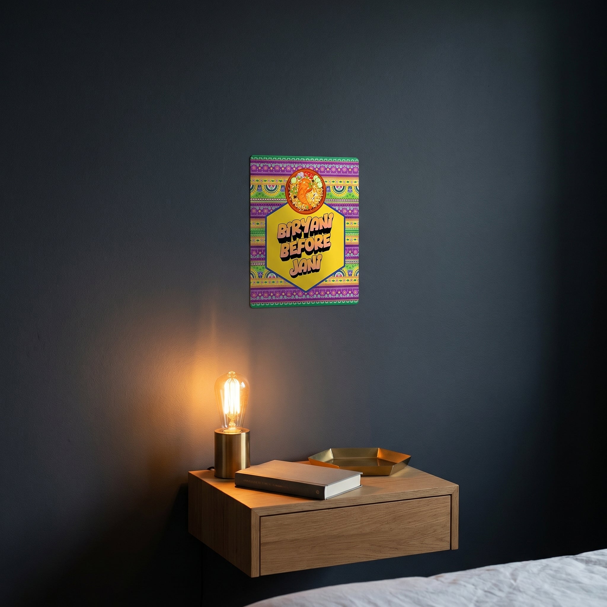 Pop-art style funny Urdu Hinglish phrase metal print catching warm ambient light from a lamp on a contemporary dark bedroom nightstand.
