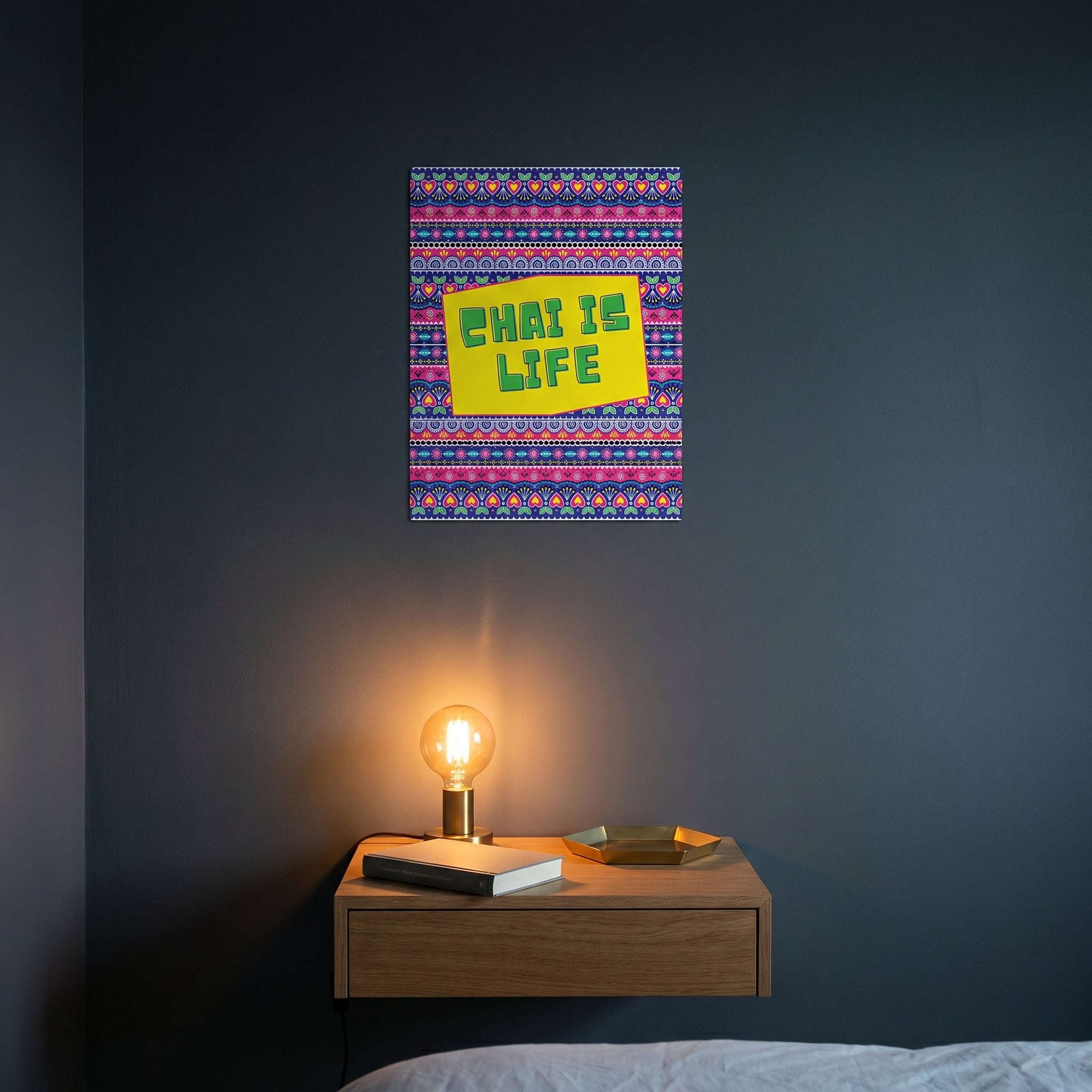  The Chai Is Life artwork catching warm ambient light from a small lamp above a contemporary wooden bedroom nightstand setup.
