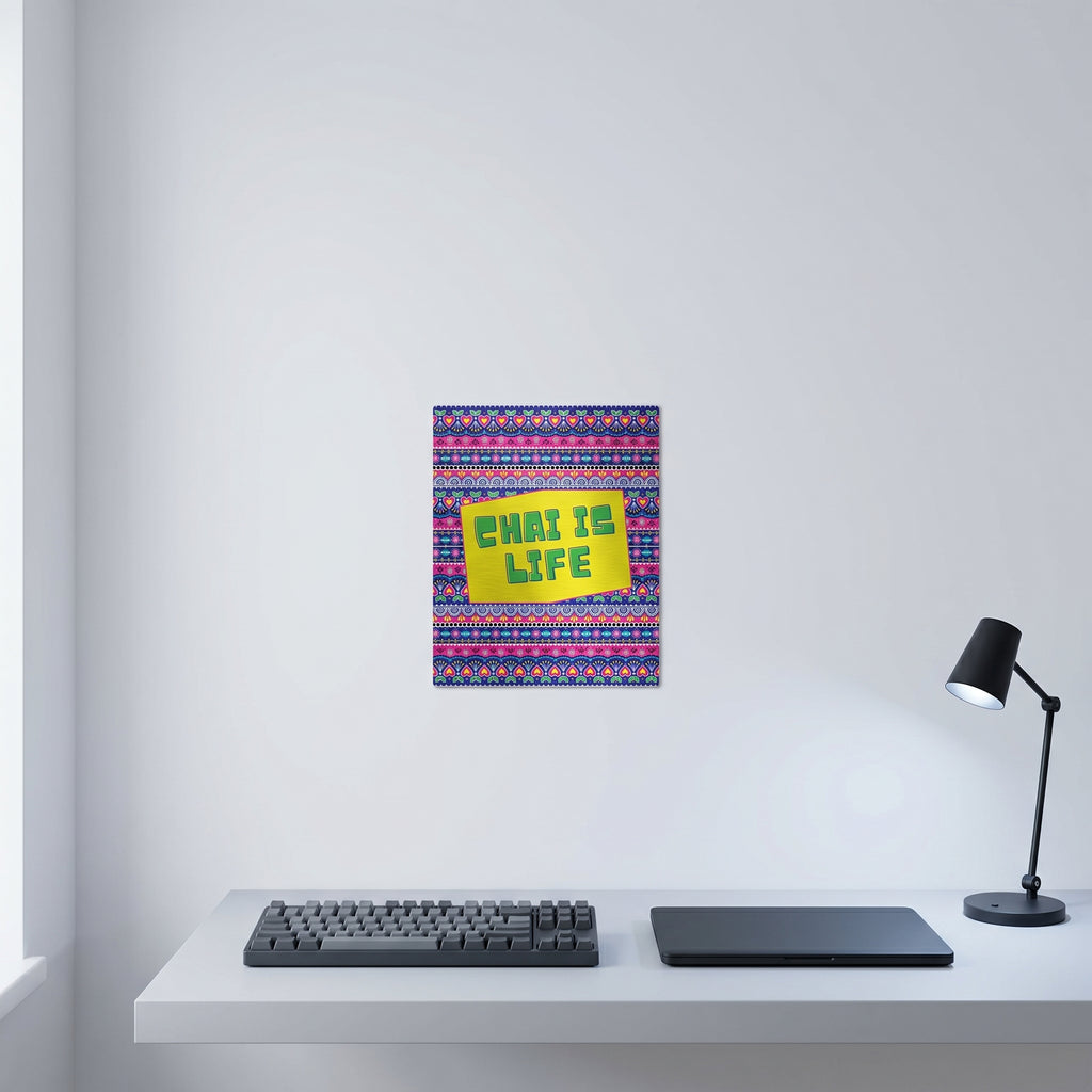  The Chai Is Life artwork displayed on a crisp white wall behind a modern minimalist home office workspace with a keyboard and desk lamp.
