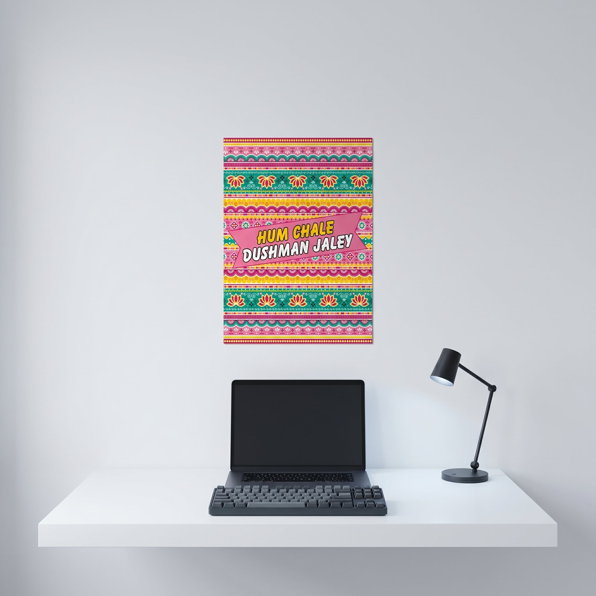 Traditional style Pakistani truck art aluminum print displayed on a crisp white wall behind a minimalist home office desk setup.
