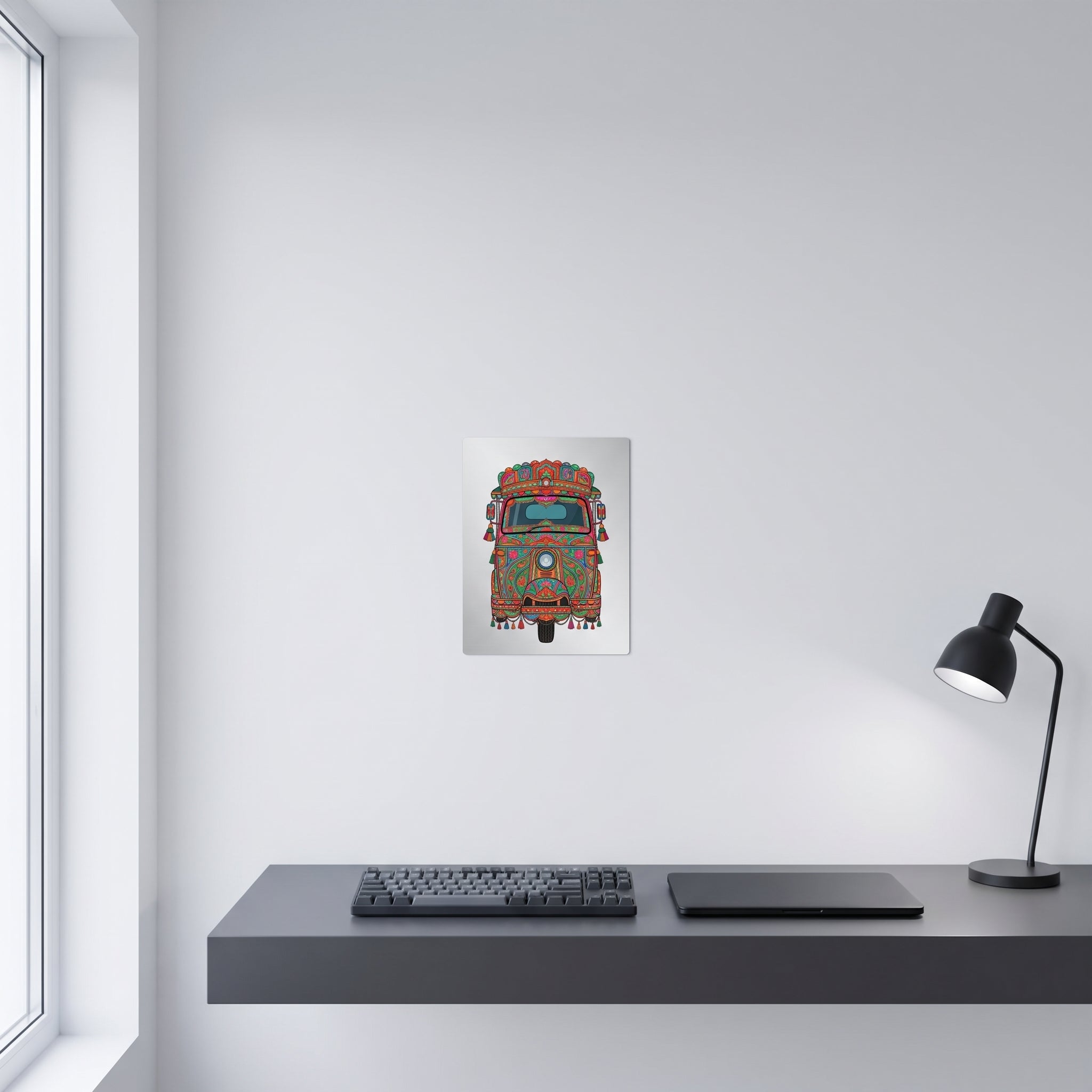 Vibrant Pakistani folk art statement sign styled on a crisp white wall behind a minimalist home office desk setup with a keyboard.