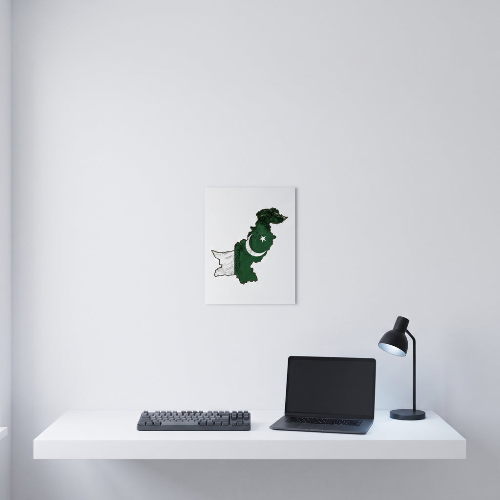 Vibrant Pakistani map statement sign styled on a crisp white wall behind a minimalist home office desk setup with a keyboard.