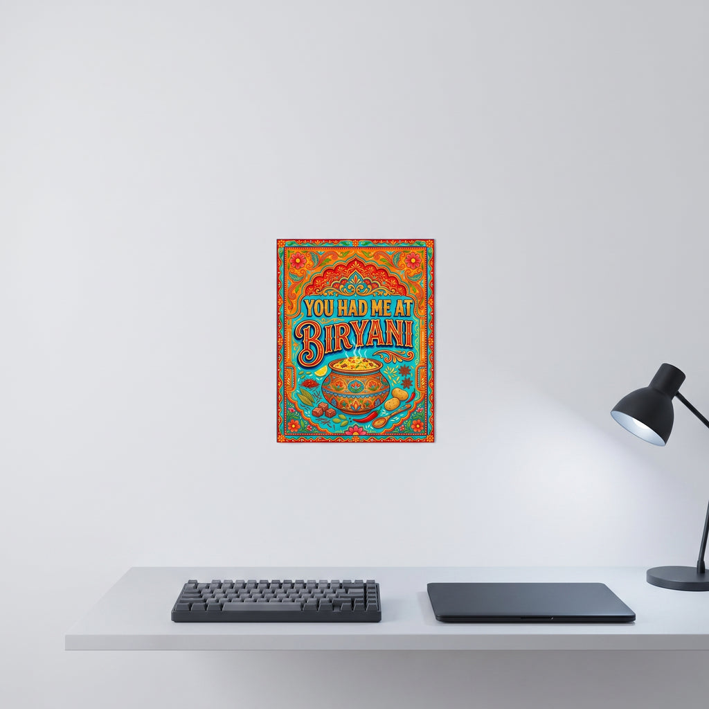 Vibrant Pakistani folk art statement sign styled on a crisp white wall behind a minimalist home office desk setup with a keyboard.